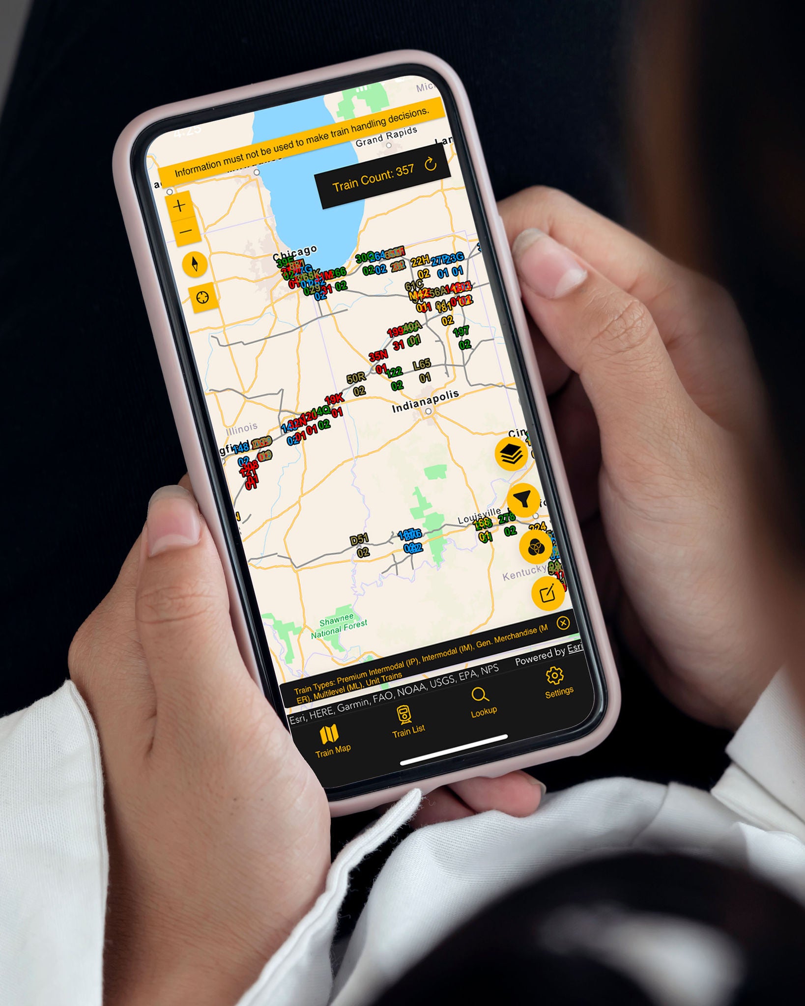 The hands of a Norfolk Southern employee hold a cellphone with a screen that depicts a tracking map that helps assist the company in their infrastructure technology efforts. 