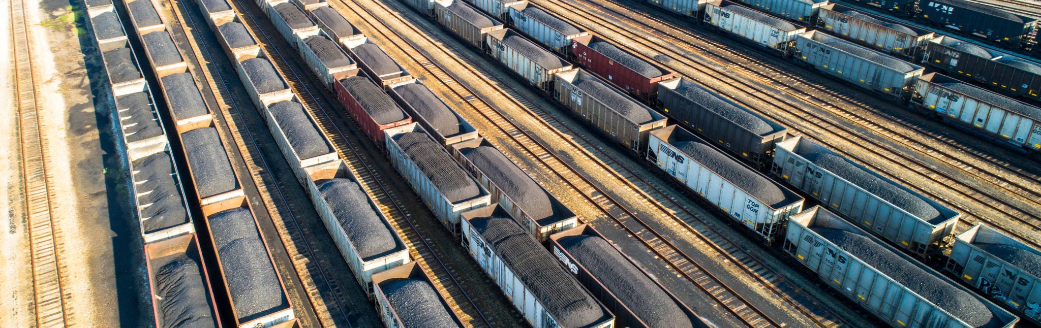 An aerial shot of coal trains at a Norfolk Southern coal transportation coal loading pier. 