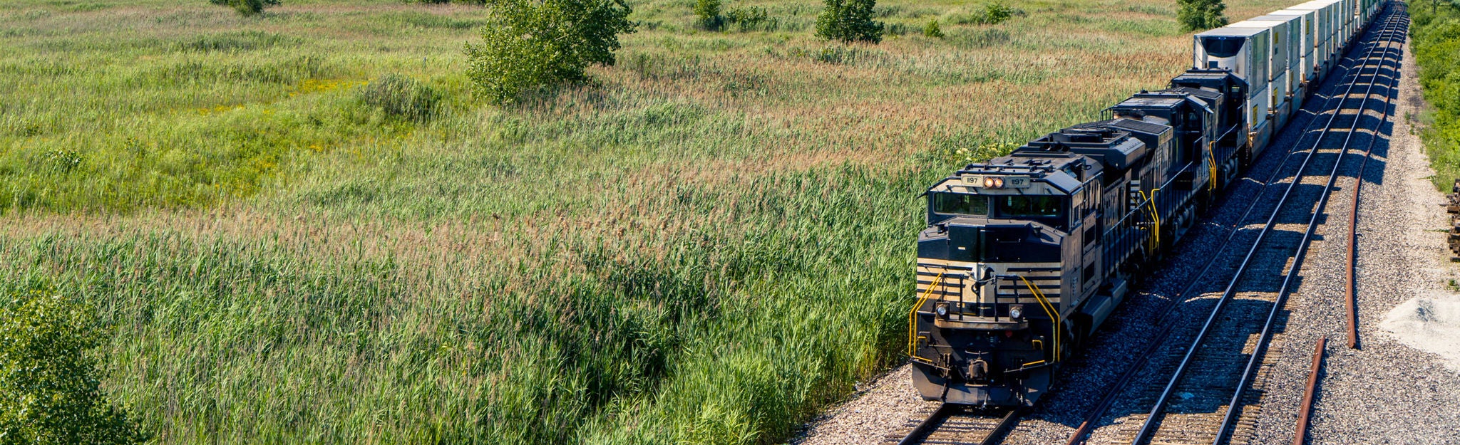 Community Affairs More Services_HERO Train moving through farmland