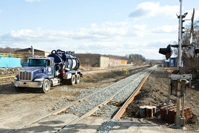 A liquid containment rig helps crews remove standing water from the site to prevent runoff.