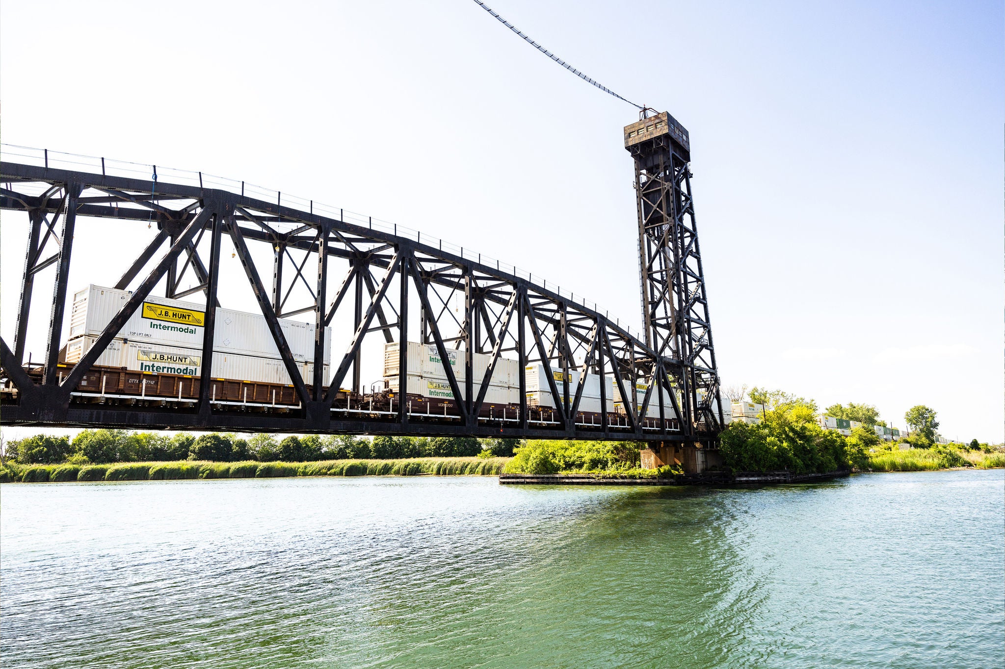 A wide angle shot showing Norfolk Southern’s automobile transport rail moving across a bridge.