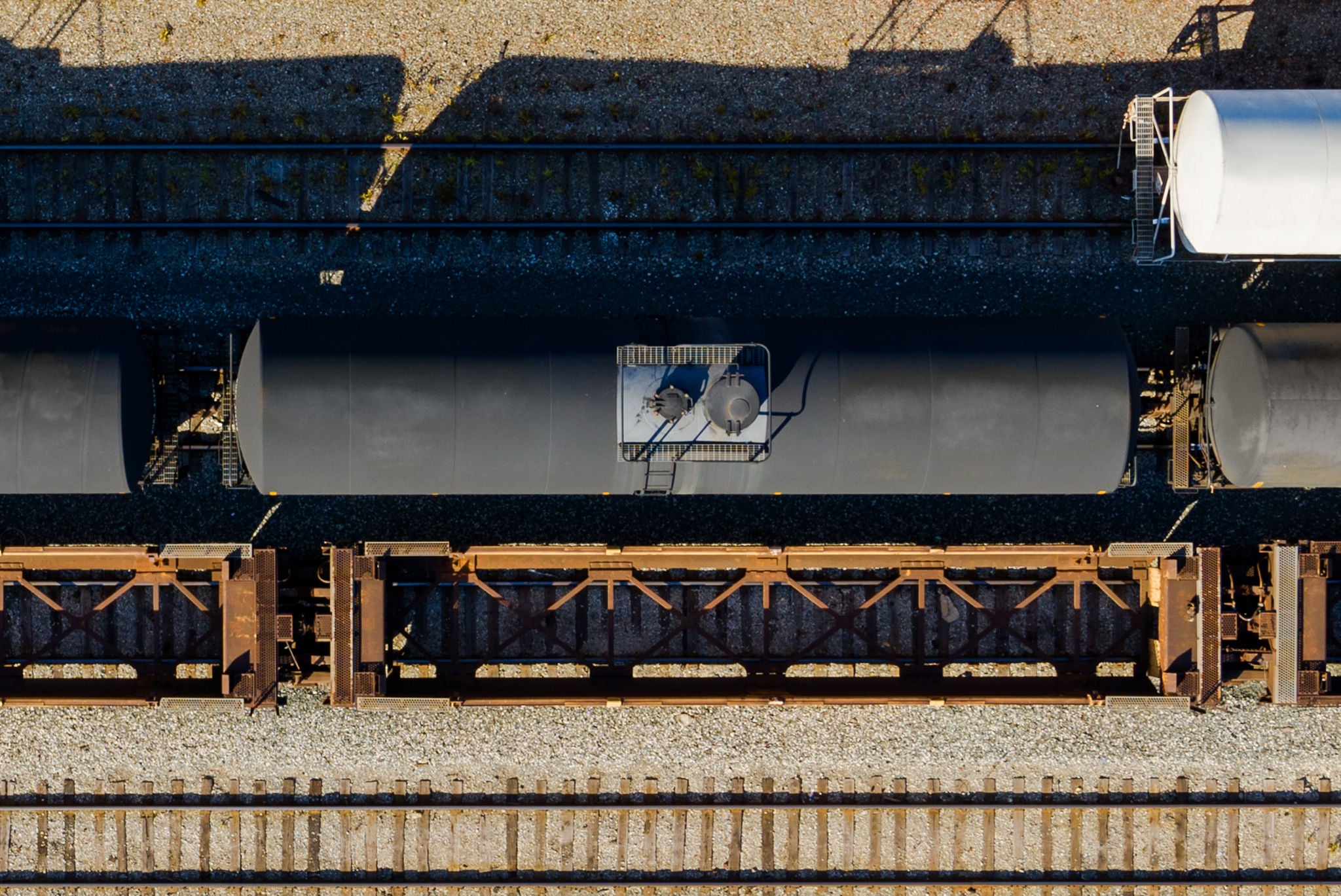 Aerial view of black tank car on a track representing ways to help find your shipping industry