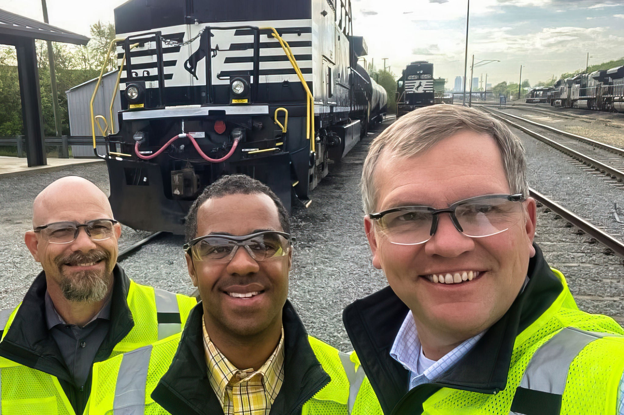 Norfolk Sothern CEO and two employees are on site at an intermodal transport working on DEI initiatives. 