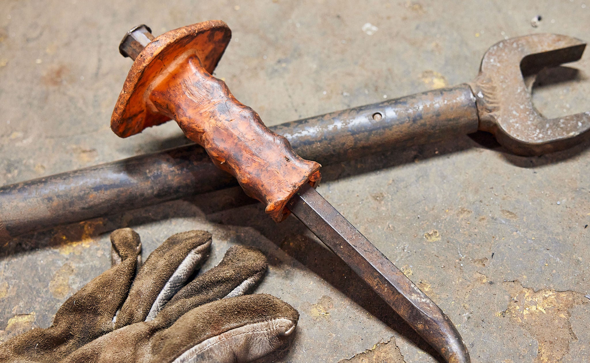 Two tools in a pile with a close up of gloves 