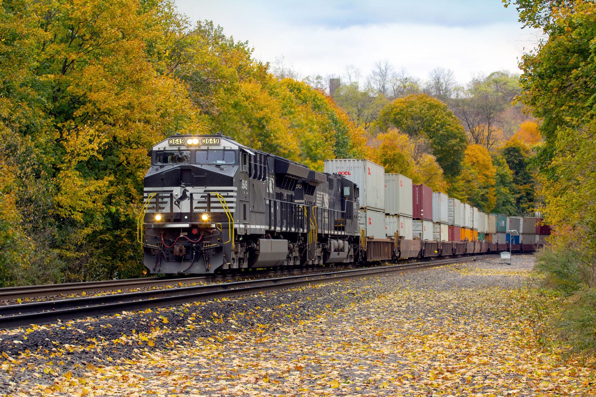 It’s fall in Central Pennsylvania as a westbound intermodal train passes through a particularly colorful area east of Tyrone, PA. The train is made up of mostly international containers, which are more than likely destined for one of the major ports on the west coast. Taken: 10/27/2019
