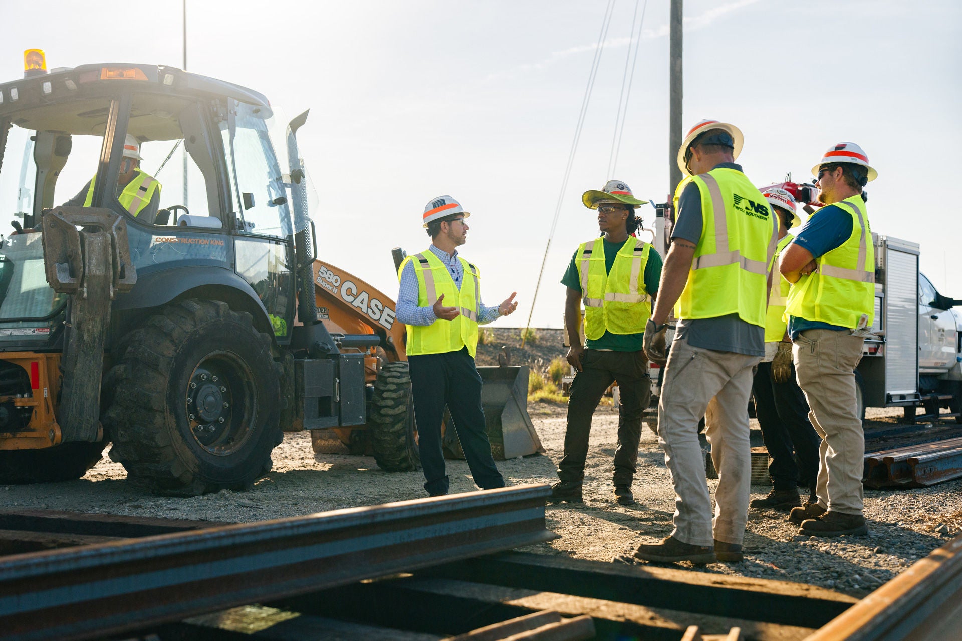 Dwayne Gibson in rail yard with employees
