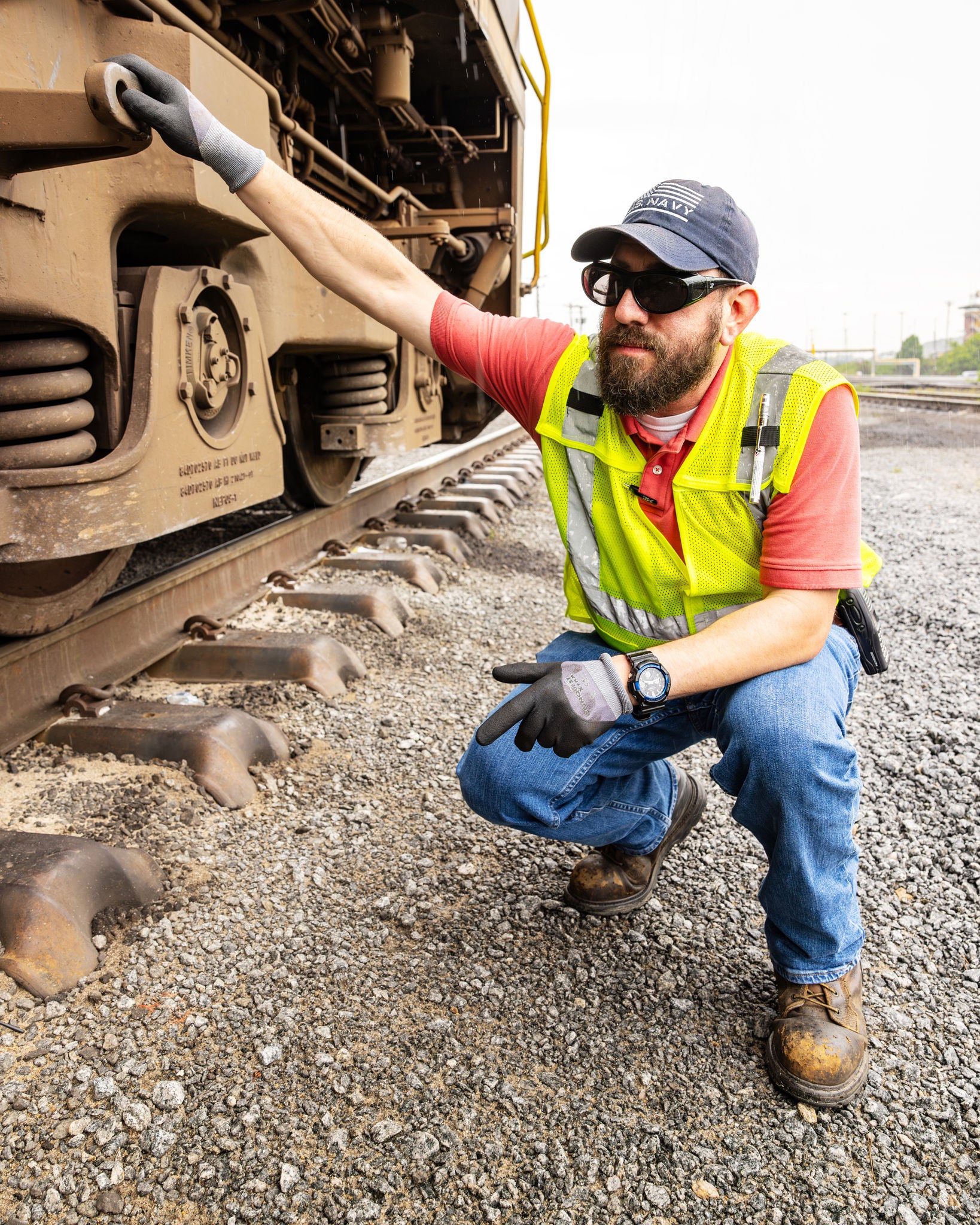 Norfolk Southern railroad employee in the transportation industry inspecting a train