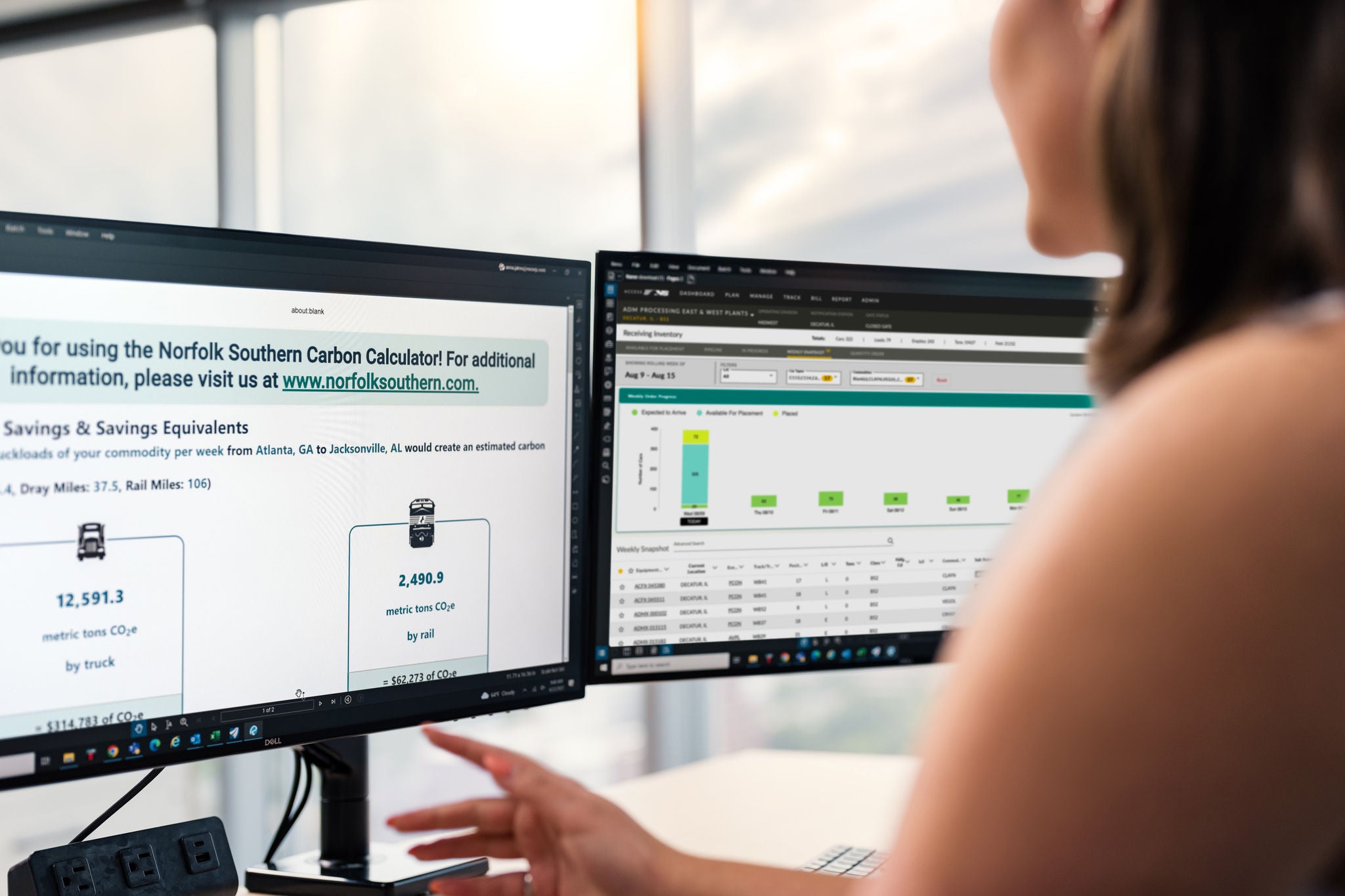 Over the shoulder image of a women working at a computer looking to calculate her carbon savings for shipping agricultural products