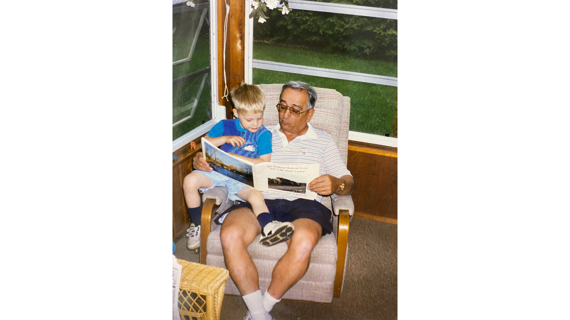 Brian Yeager reading book with grandfather