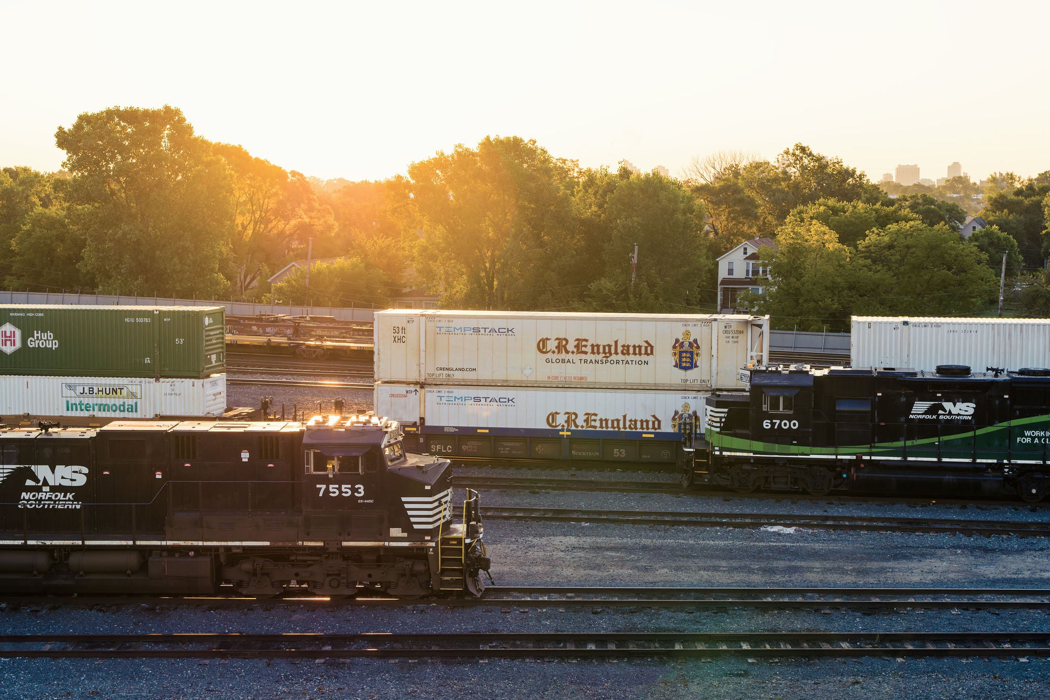 Two Norfolk Southern intermodal shipping trains heading in opposite directions on the company’s railway tracks.