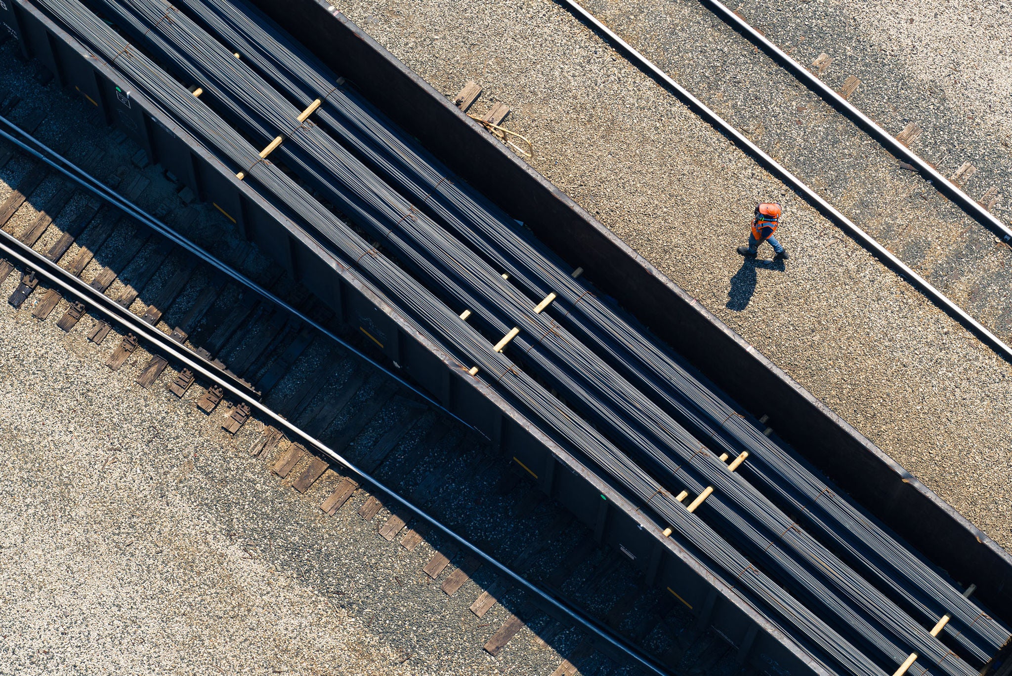 Gondola train car on a track carrying metals and construction items inspiring you to find your shipping industry