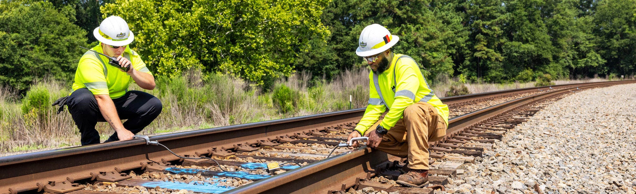 norfolk southern employees using safety technology on track Two Norfolk Southern rail employees using safety technology to enhance rail safety