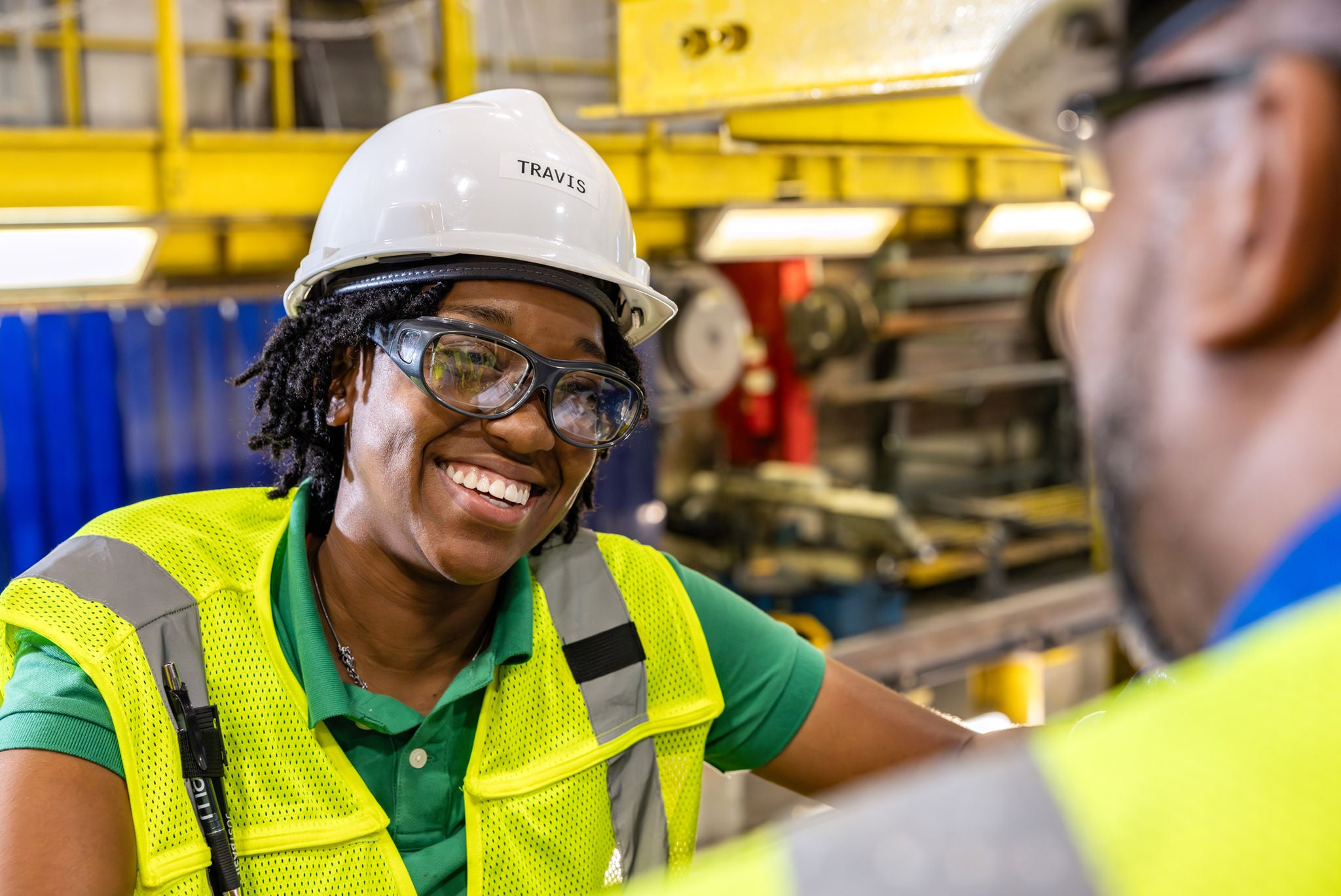 norfolk southern ops employee woman in railway job and dispatcher job smiling with safety gear