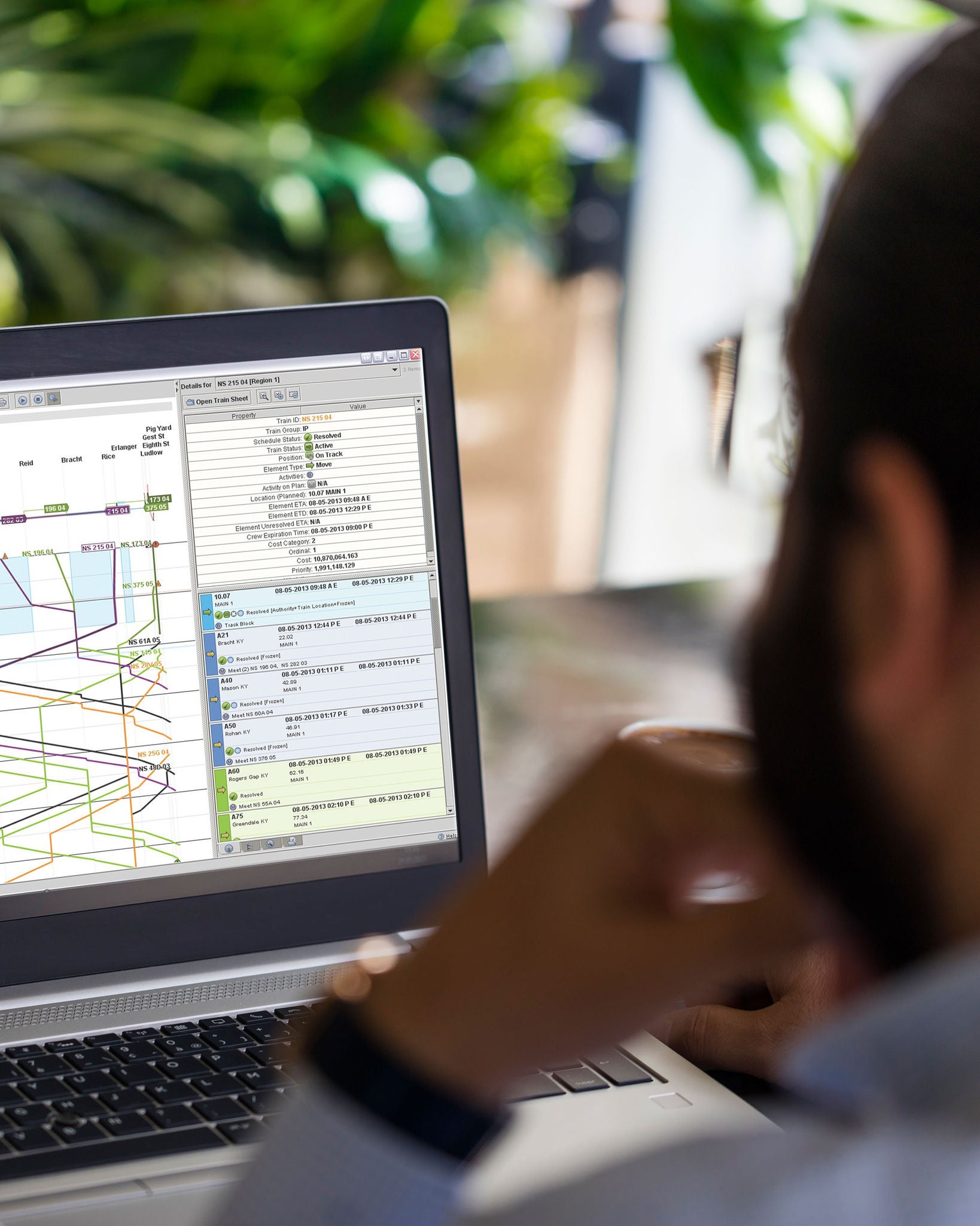 An over-the-shoulder shot of a Norfolk Southern employee viewing the railway technology train plans on his computer screen.