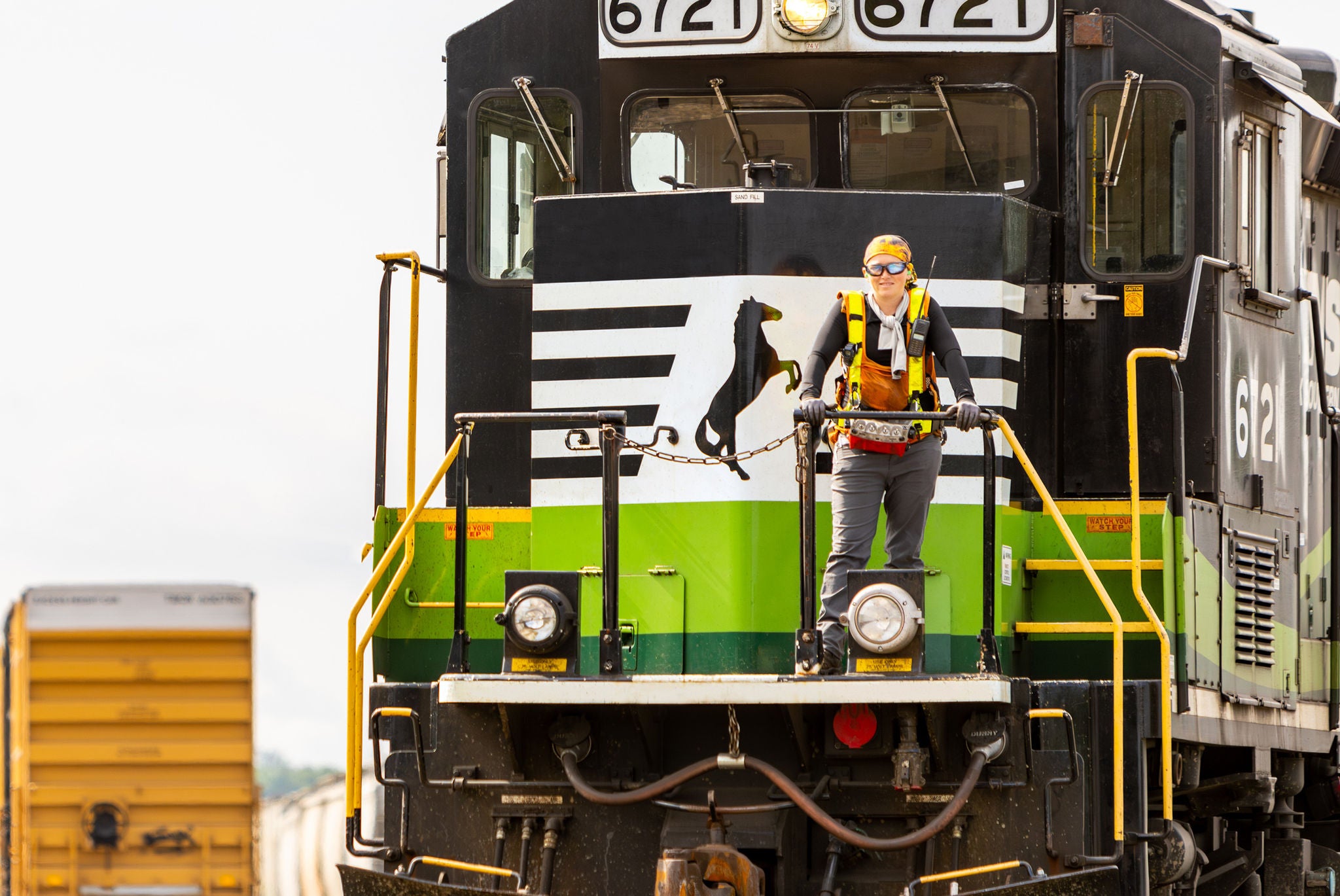 Person standing on the front of railroad industry leader Norfolk Southerns eco locomotive