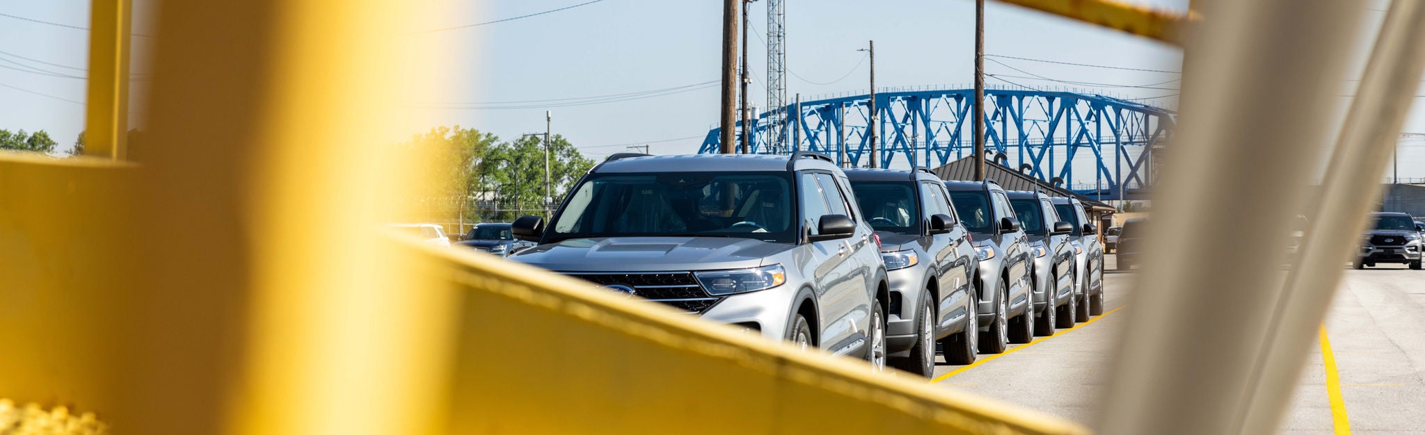 Automotive Rail Shipping Parked Car Line A partially blocked view of a line of cars parked and ready for automotive rail shipping.
