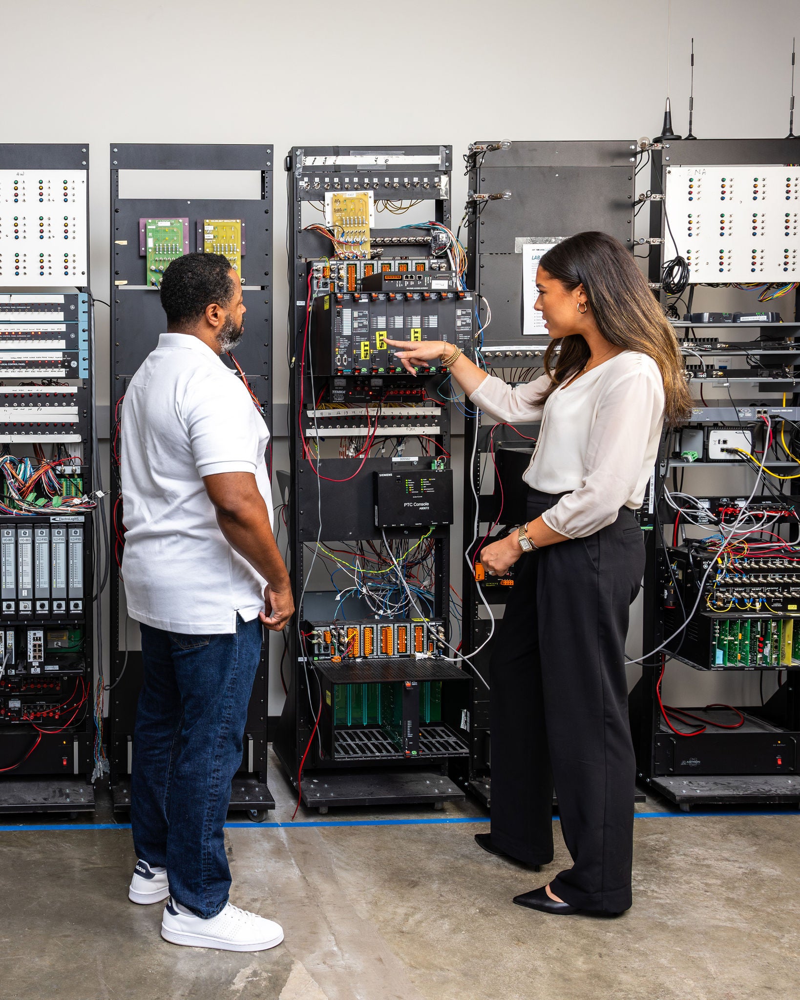 A man and women in the transportation industry look at a server