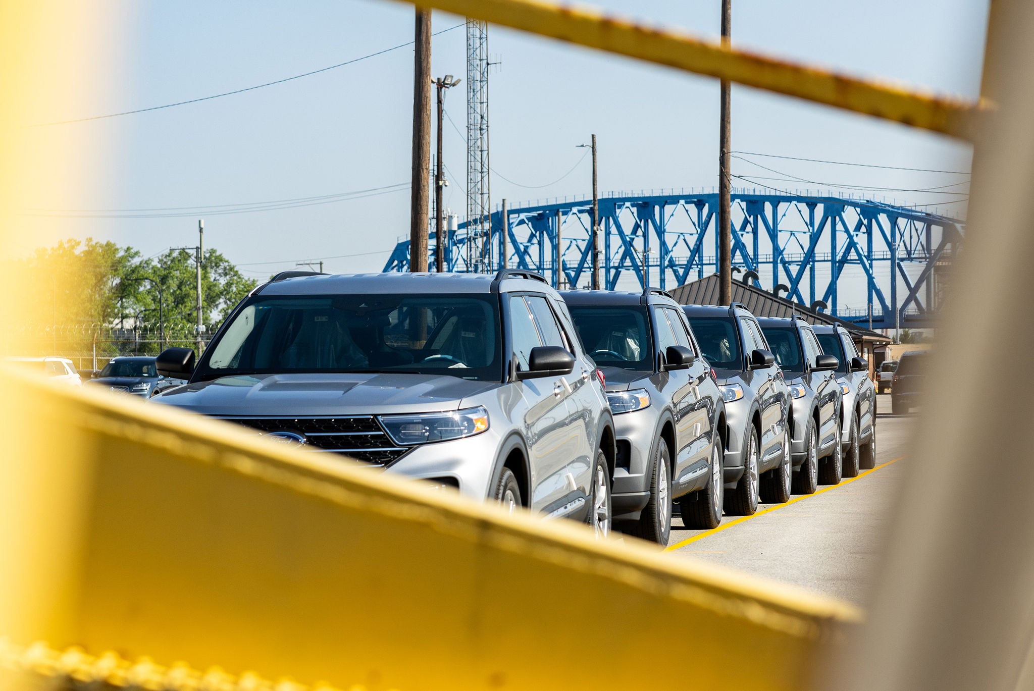 Line of cars viewed through a yellow barrier helping to find your shipping industry