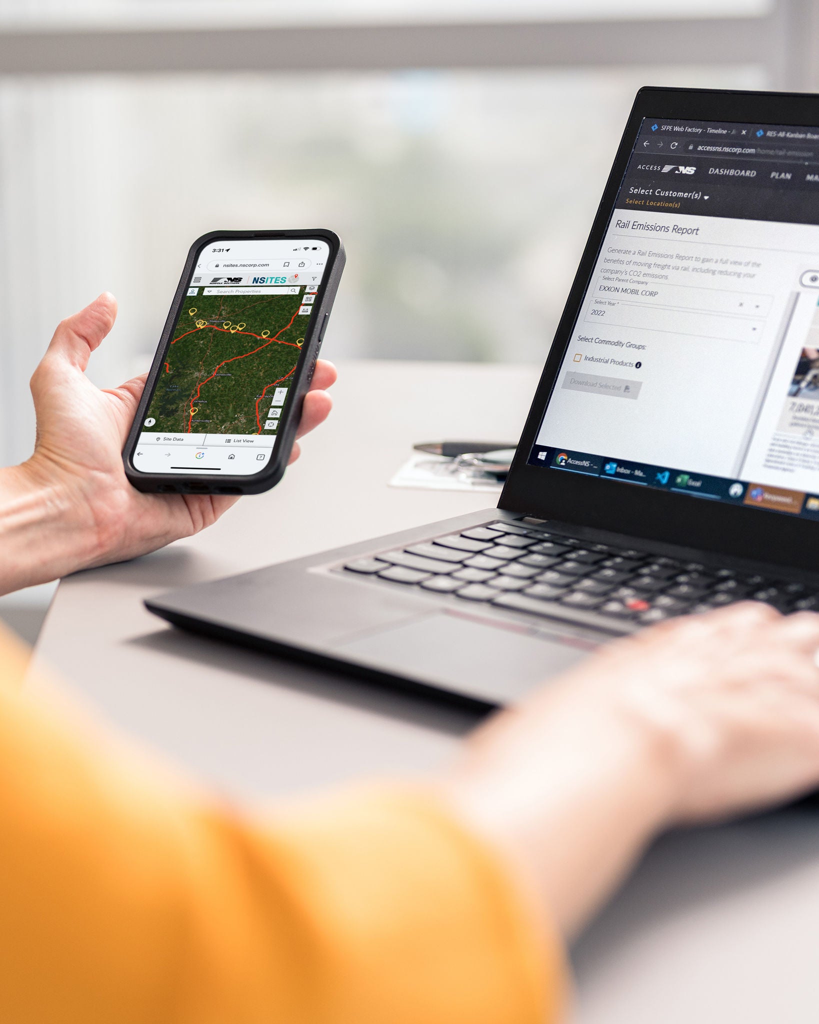 Person with close up of phone and computer looking for an industrial development site