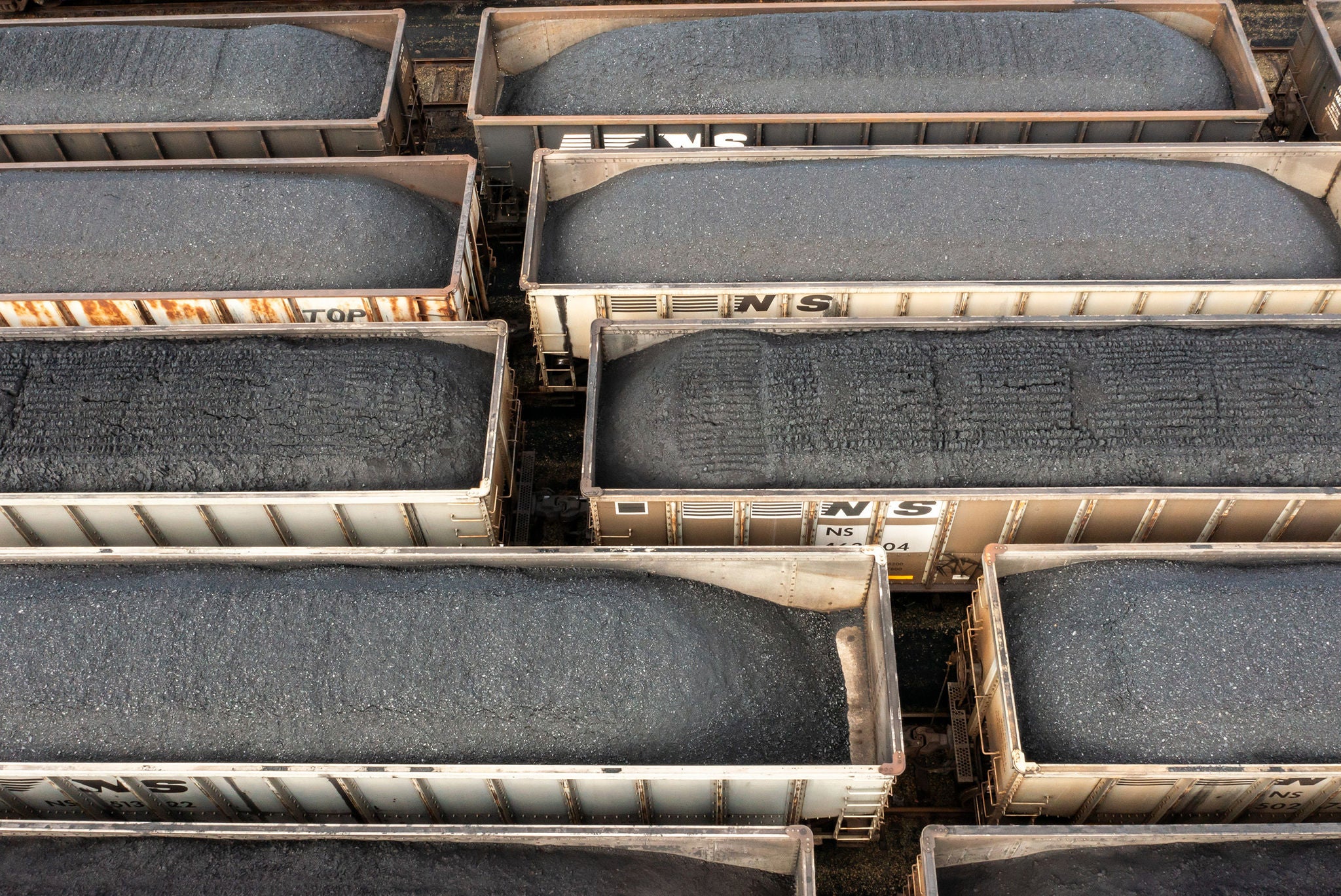 Multiple gondola train cars full on coal on a track representing ways to find your shipping industry