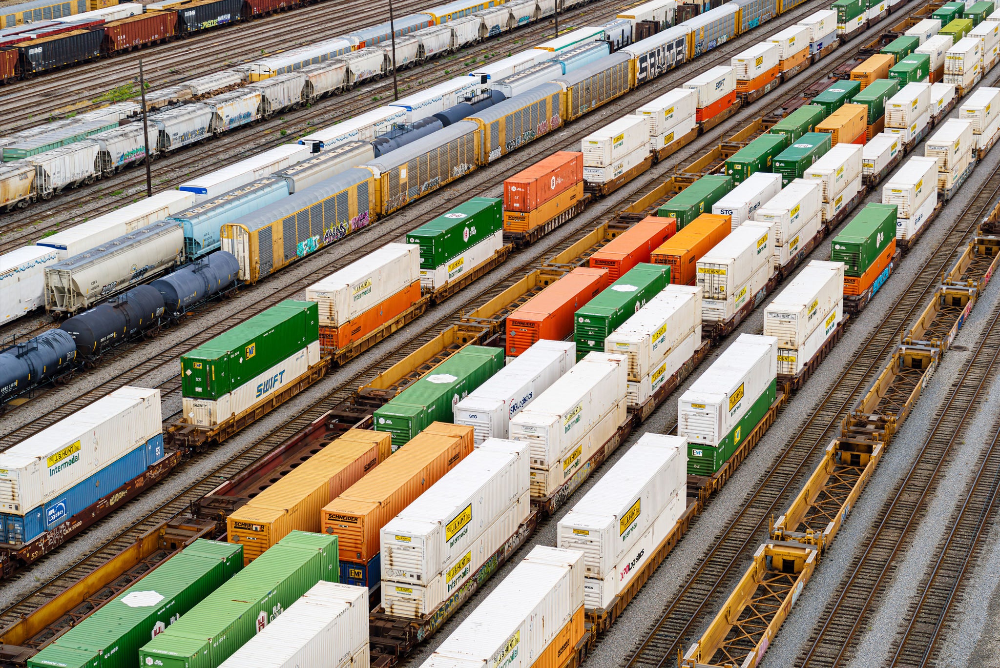 Aerial view of multiple transportation industry rail shipping containers on railroad track