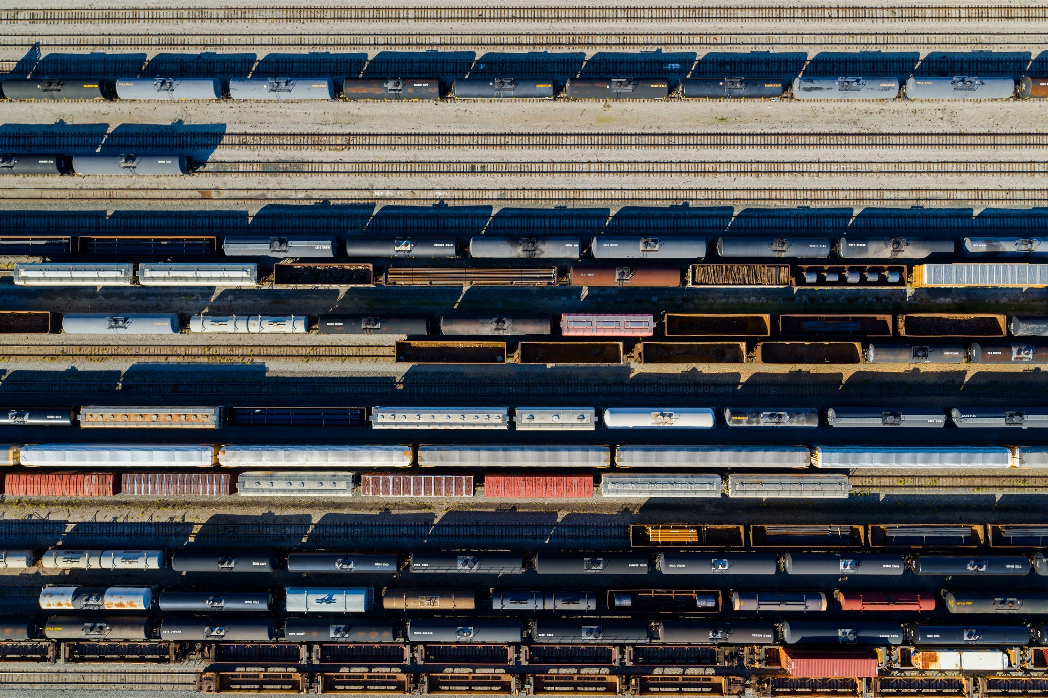 Aerial view of multiple trains in a train yard that are shipping metals by rail
