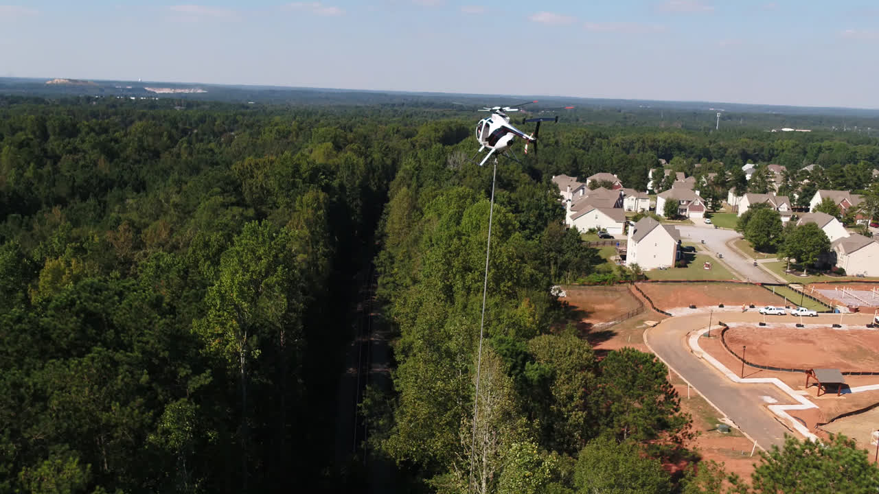 Captured by drone above Norfolk Southern's H Line in McDonough, Georgia, this video shows a helicopter supporting vegetation management efforts along the railroad.