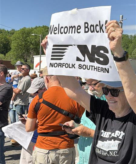 Person holding sign at Old Fort Loops reopening