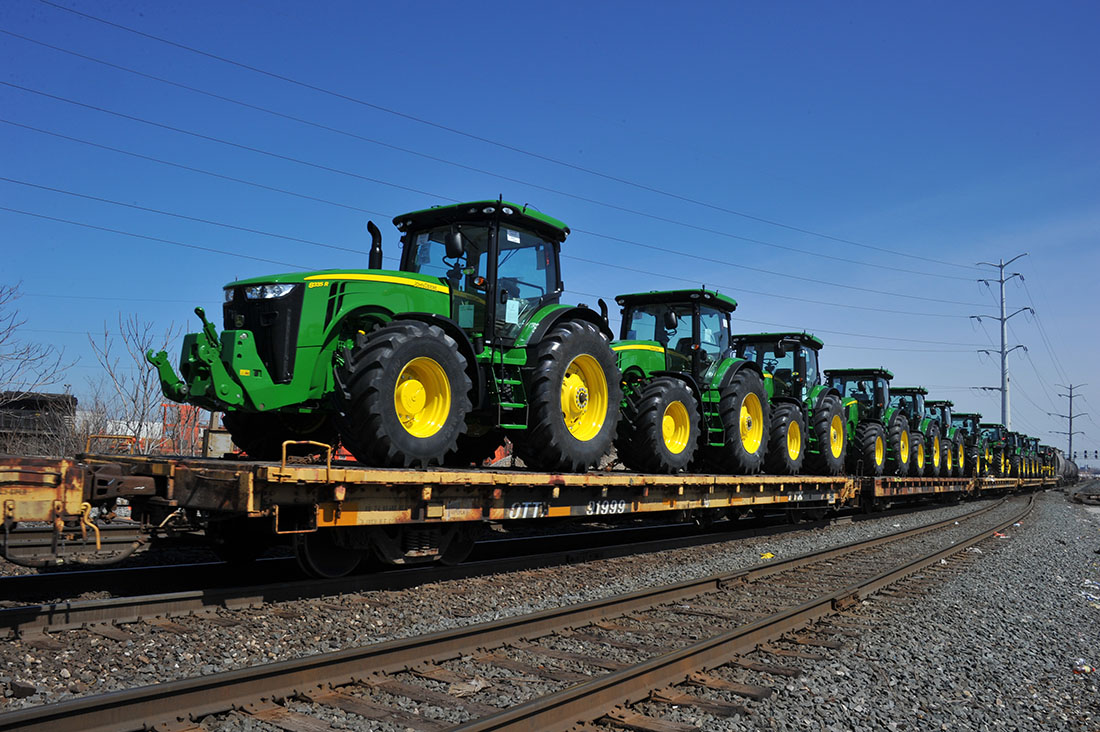 Flat cars full of John Deere tractors move through Englewood Flyover in Chicago, IL.