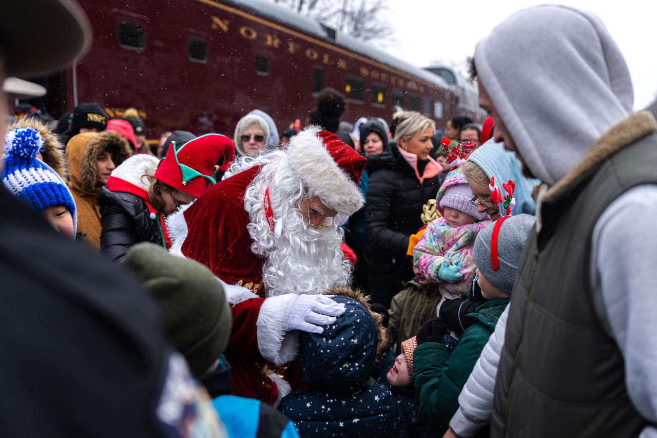 Santa Claus in a crowd of people at Toys for Tots Holiday Train event
