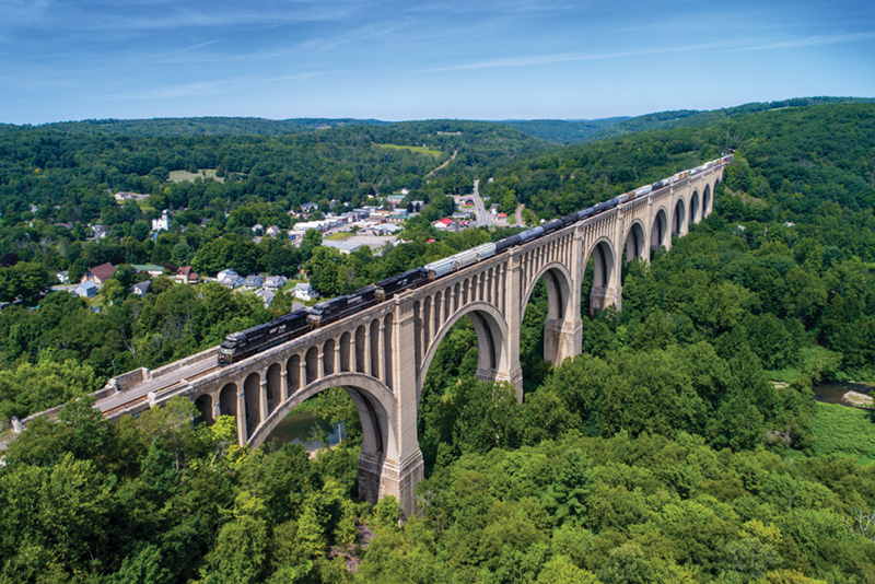 Cory Rusch, conductor, Buffalo, New York. In his photo, a mixed-freight train crossing the massive Tunkhannock Creek Viaduct in Nicholson, Pennsylvania, was surrounded by the tops of leafy green trees.