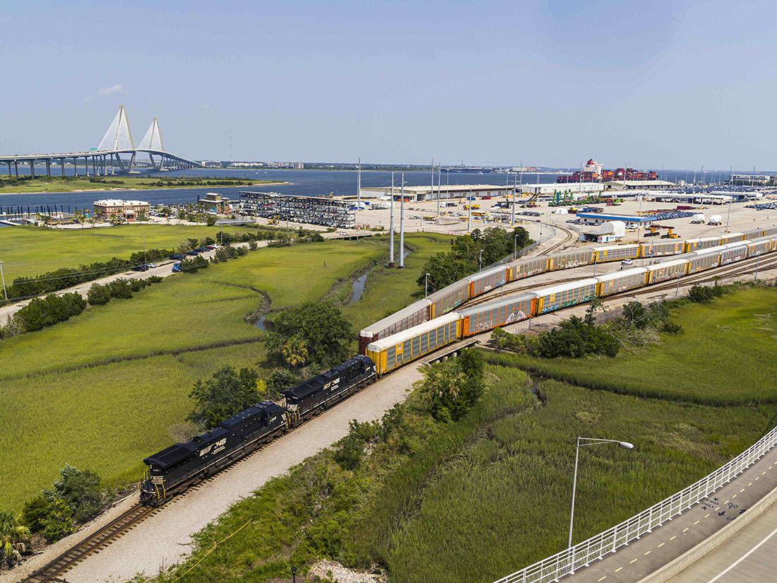 Overhead shot of auto rack consist leaving the Port of Charleston, Ravenel bridge in distance.